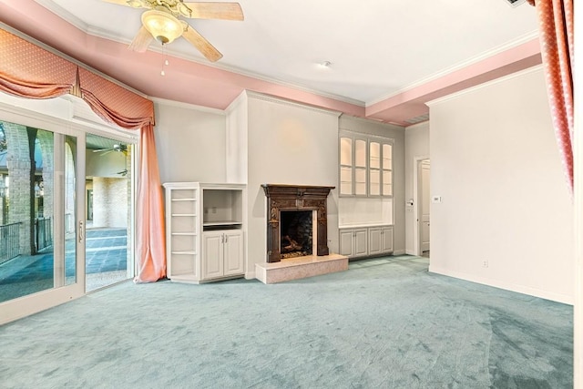 unfurnished living room with a ceiling fan, light carpet, crown molding, and a premium fireplace