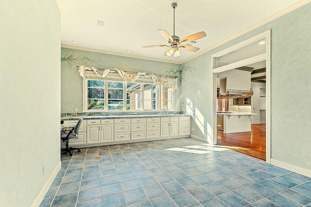 bathroom featuring a sink, ceiling fan, baseboards, and crown molding