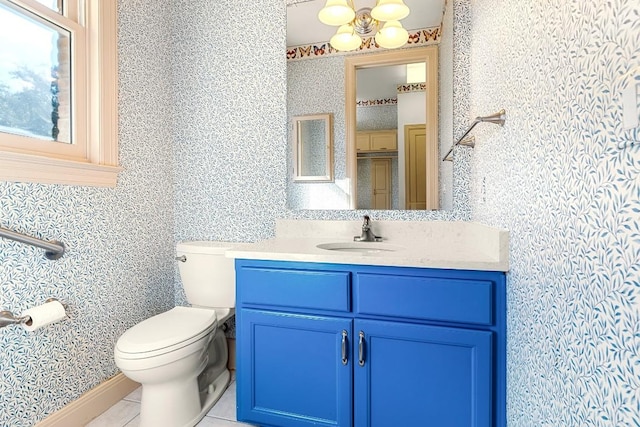 bathroom featuring toilet, tile patterned floors, vanity, and wallpapered walls