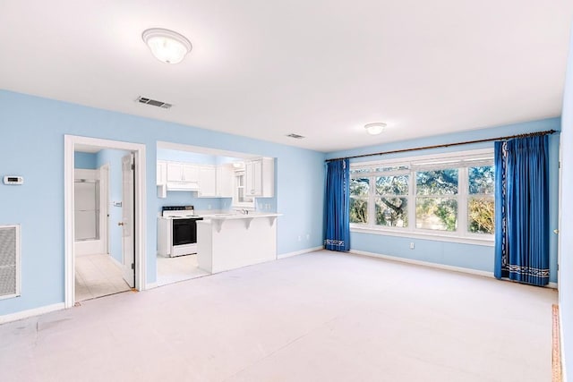 unfurnished living room featuring visible vents and baseboards