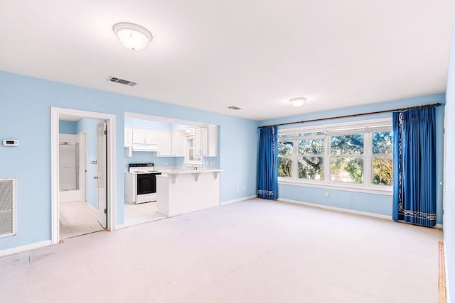 unfurnished living room featuring baseboards