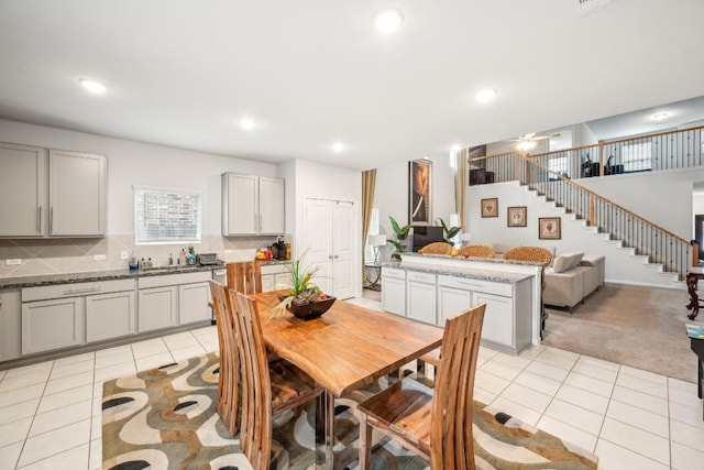 tiled dining area featuring ceiling fan