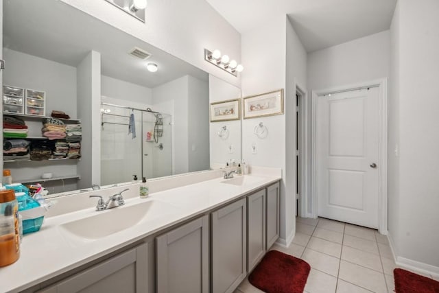 bathroom featuring walk in shower, vanity, and tile patterned flooring