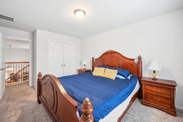 bedroom featuring light carpet and a closet