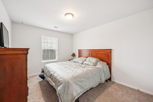 bedroom featuring light colored carpet