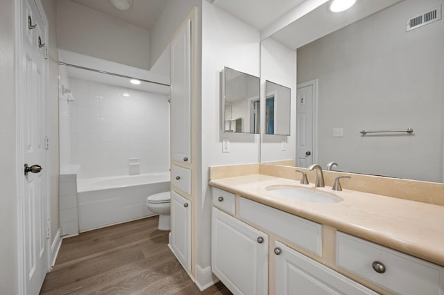 full bathroom with vanity, wood-type flooring,  shower combination, and toilet