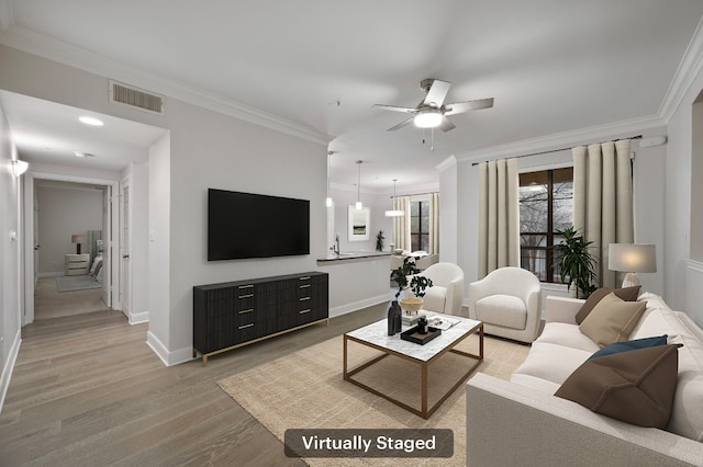 living room with sink, crown molding, wood-type flooring, and ceiling fan