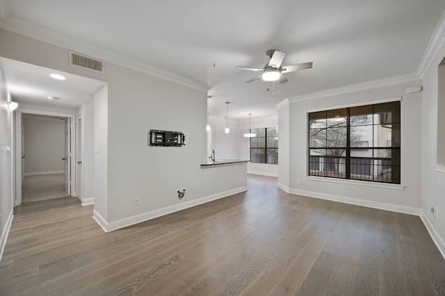 unfurnished room with ceiling fan, ornamental molding, and hardwood / wood-style floors