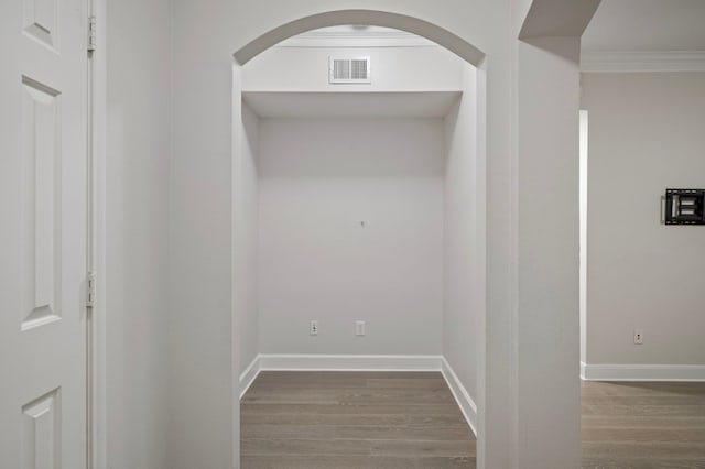 hallway featuring crown molding and wood-type flooring