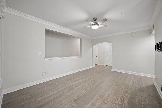 empty room with crown molding, wood-type flooring, and ceiling fan