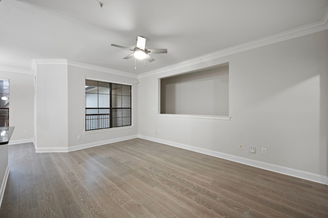 empty room with hardwood / wood-style flooring, crown molding, and ceiling fan