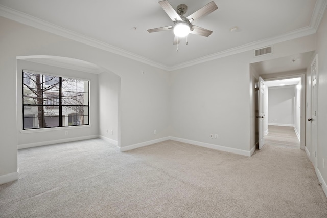 spare room featuring crown molding, ceiling fan, and light carpet