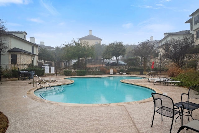 view of swimming pool with a patio area