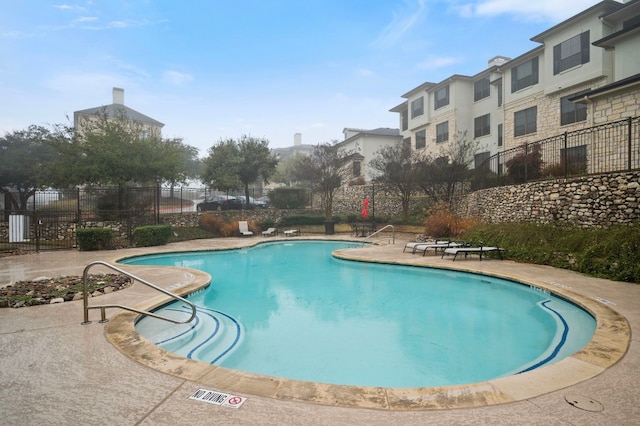 view of swimming pool with a patio area