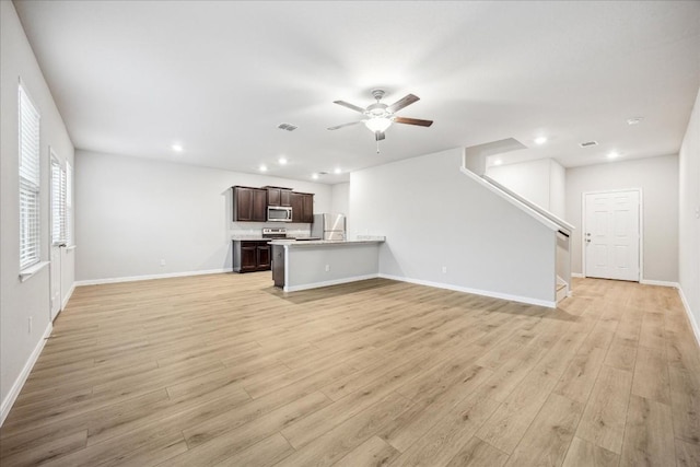 unfurnished living room featuring ceiling fan and light hardwood / wood-style flooring