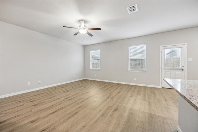 unfurnished living room featuring ceiling fan and light wood-type flooring