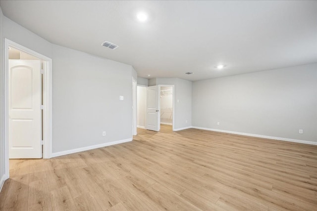 empty room with light hardwood / wood-style flooring