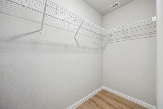 spacious closet featuring hardwood / wood-style flooring