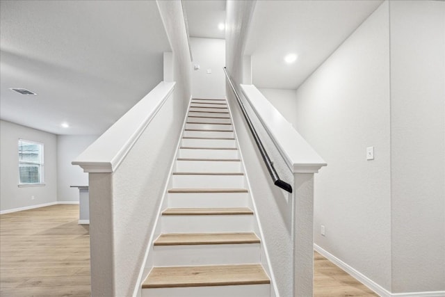 staircase featuring hardwood / wood-style flooring