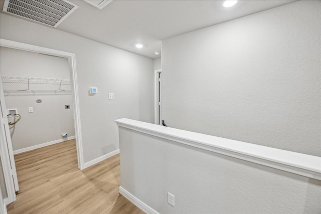 hallway with light hardwood / wood-style flooring