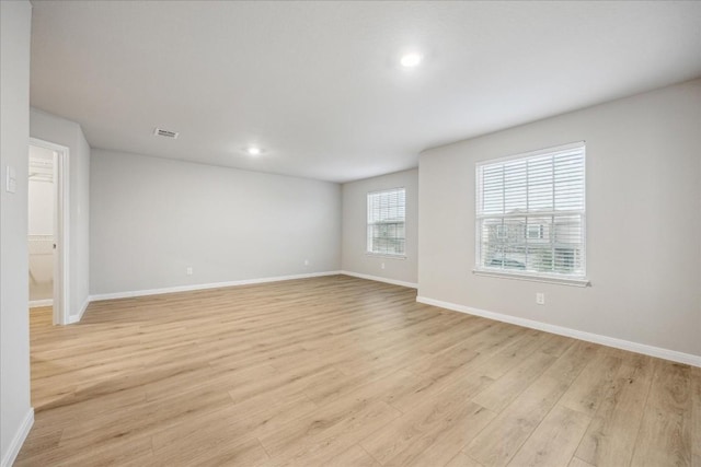 spare room with light hardwood / wood-style flooring