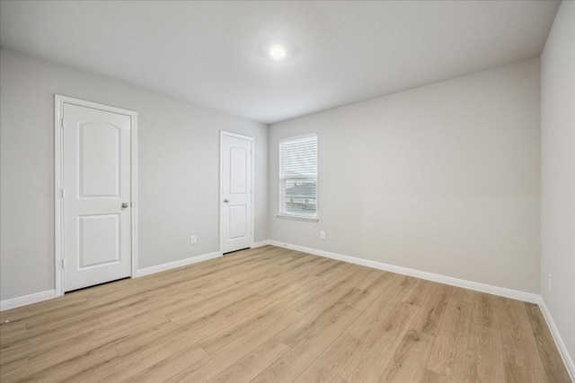 spare room with light wood-type flooring