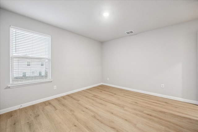 spare room featuring light hardwood / wood-style flooring