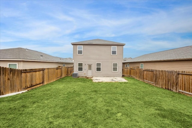 rear view of house with a patio, central AC unit, and a lawn