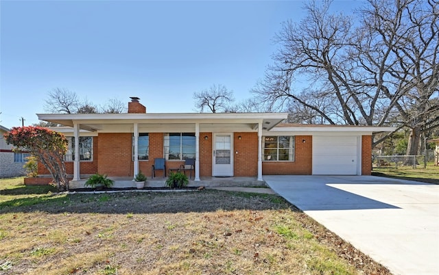 ranch-style house featuring a garage, a front yard, and covered porch