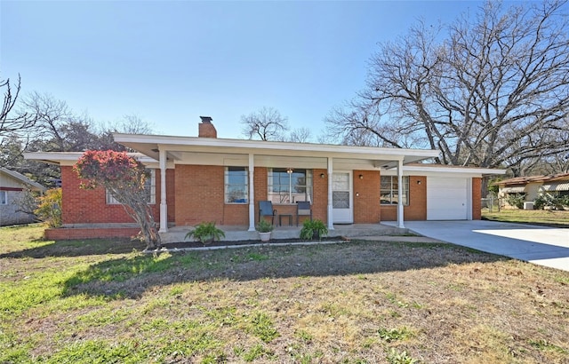 single story home featuring a garage, covered porch, and a front yard