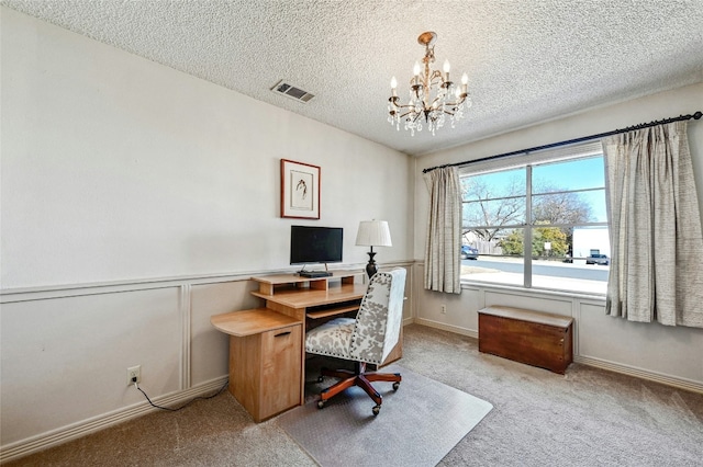 carpeted office featuring a chandelier and a textured ceiling