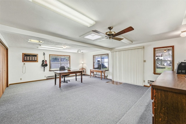 carpeted office space with ceiling fan, a wall mounted air conditioner, a textured ceiling, and a baseboard heating unit