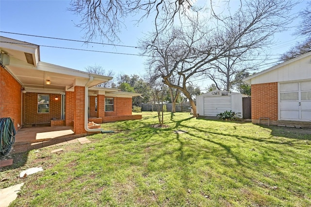 view of yard featuring a patio and a storage shed