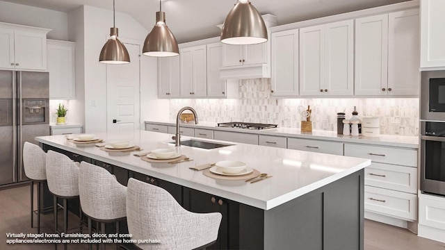 312 Leaning Rock Rdg, Austin, TX 78737 - kitchen featuring stainless steel appliances, light countertops, wood finished floors, decorative backsplash, and white cabinets