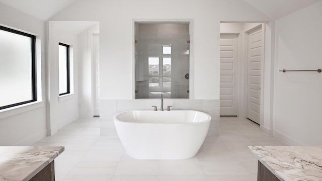 312 Leaning Rock Rdg, Austin, TX 78737 - bathroom with lofted ceiling, healthy amount of natural light, a freestanding tub, and vanity