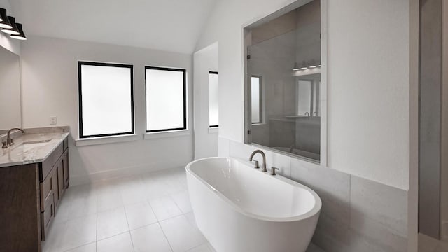 312 Leaning Rock Rdg, Austin, TX 78737 - bathroom with a freestanding bath, vanity, lofted ceiling, and tile patterned flooring