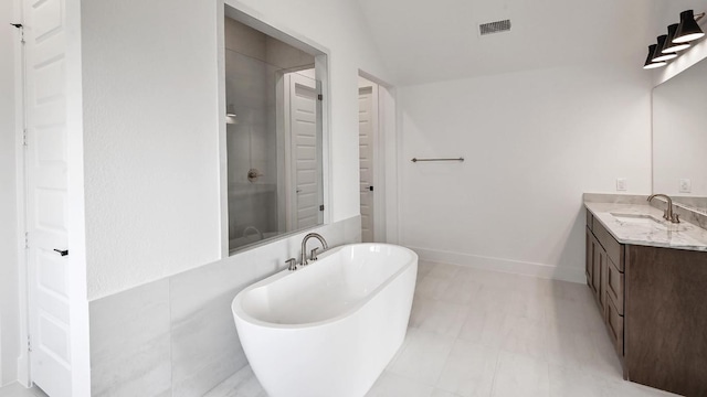 312 Leaning Rock Rdg, Austin, TX 78737 - full bathroom with vanity, a freestanding tub, a stall shower, and tile patterned floors