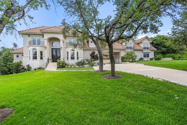 mediterranean / spanish-style house featuring a front yard