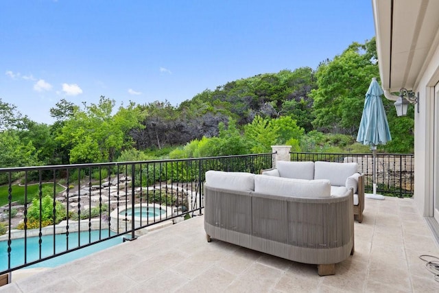 view of patio / terrace featuring a fenced in pool, an outdoor living space, and a balcony