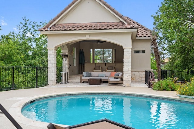 view of swimming pool with outdoor lounge area, a patio, and ceiling fan