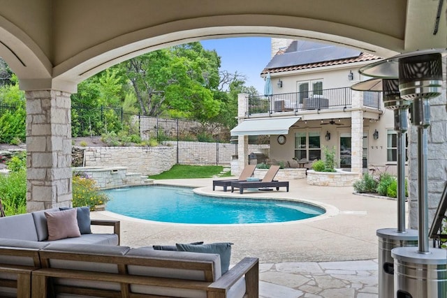 view of pool featuring outdoor lounge area and a patio