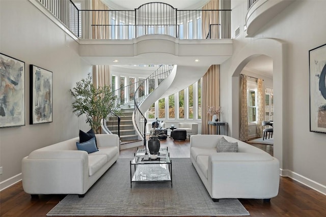 living room featuring dark hardwood / wood-style floors and a high ceiling