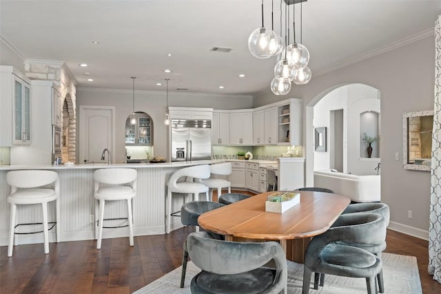 dining space featuring crown molding and dark hardwood / wood-style floors