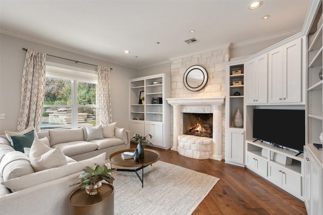 living room with crown molding, dark wood-type flooring, and a fireplace