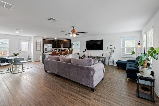 living room with ceiling fan, dark hardwood / wood-style floors, and a healthy amount of sunlight