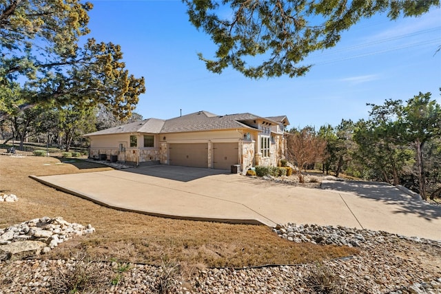 804 Laughing Dog Ct, Leander, TX 78641 - view of property exterior featuring stone siding, a garage, and concrete driveway