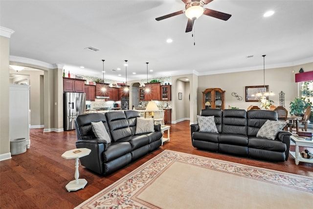 804 Laughing Dog Ct, Leander, TX 78641 - living area with arched walkways, a ceiling fan, recessed lighting, dark wood finished floors, and a chandelier