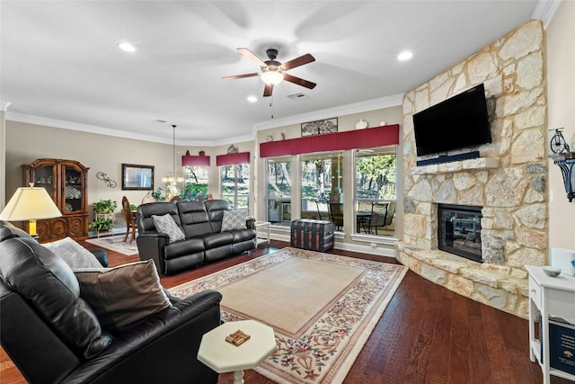 804 Laughing Dog Ct, Leander, TX 78641 - living area with ceiling fan, a stone fireplace, wood finished floors, crown molding, and a chandelier