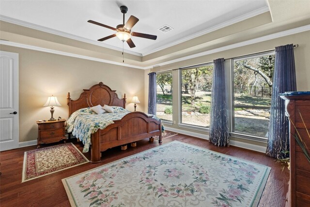 804 Laughing Dog Ct, Leander, TX 78641 - bedroom with wood finished floors, crown molding, a raised ceiling, and ceiling fan