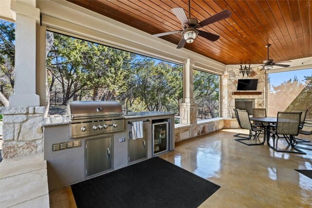 804 Laughing Dog Ct, Leander, TX 78641 - view of patio / terrace featuring wine cooler, an outdoor stone fireplace, outdoor dining space, and ceiling fan